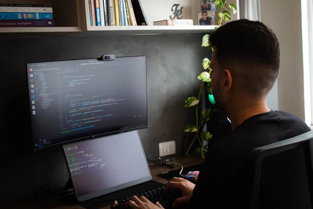 Entwickler arbeitet an einer Fachanwendung an einem Zwei-Monitor-Arbeitsplatz